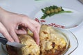 A woman is cutting a meatloaf. Preparation of minced meat rolls. As a stuffing boiled egg. Slices of the finished roll are on a pl Royalty Free Stock Photo