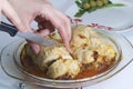 A woman is cutting a meatloaf. Preparation of minced meat rolls. As a stuffing boiled egg. Slices of the finished roll are on a pl Royalty Free Stock Photo