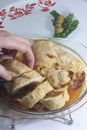 A woman is cutting a meatloaf. Preparation of minced meat rolls. As a stuffing boiled egg. Slices of the finished roll are on a pl Royalty Free Stock Photo