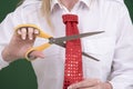 Woman cutting through a necktie with scissors Royalty Free Stock Photo
