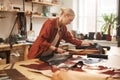 Woman Cutting Out Leather