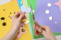 Woman cutting paper heart with scissors at white wooden table, top view Royalty Free Stock Photo