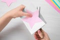 Woman cutting paper with scissors at white wooden table, top view Royalty Free Stock Photo