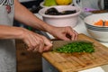 woman cutting parsley on a cutting board in the kitchen 5