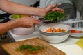 woman cutting parsley on a cutting board in the kitchen 9
