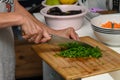 woman cutting parsley on a cutting board in the kitchen 6