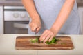 Woman cutting parsley with a knife