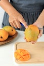 Woman Cutting Peeling Ripe Mango Royalty Free Stock Photo