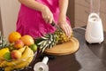 Woman cutting pineapple top Royalty Free Stock Photo