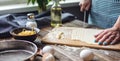 Woman is cutting raw dough with a knife to make homemade noodles. Concept of process of cooking handmade pasta Royalty Free Stock Photo