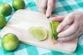 Woman cutting a slice of lime pieces Royalty Free Stock Photo