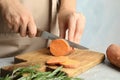 Woman cutting sweet potato on wooden board Royalty Free Stock Photo
