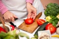 Woman cutting tomato for salad Royalty Free Stock Photo