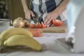 Woman cutting tomatoes on chopping board, preparing meal