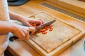 Cutting vegetable on wooden plate