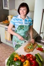 Woman cutting vegetables in the kitchen. Royalty Free Stock Photo