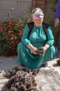 Woman cutting wool for traditional felt making