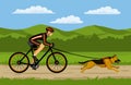 Woman cycling bikejoring with her dog