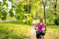 Woman cycling a mountain bike in city park, summer day Royalty Free Stock Photo