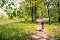 Woman cycling a mountain bike in city park, summer day Royalty Free Stock Photo