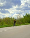 Woman cycling spring road