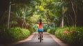 A Woman Cycling on a Tropical Park Trail, Embracing the Summer Vibes. Generative AI