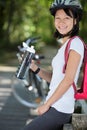 woman cyclist resting and drinking water Royalty Free Stock Photo