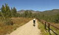 A Woman Cyclist Rides in the Fall