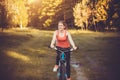 Woman cyclist rides in the forest on a mountain bike. Royalty Free Stock Photo