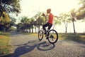Cyclist riding bike in tropical park Royalty Free Stock Photo