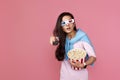 woman in 3d glasses with remote control holding bucket of popcorn Royalty Free Stock Photo