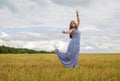 woman dance in summer field. feeling of freedom and happiness
