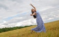 woman dance in summer field. feeling of freedom and happiness