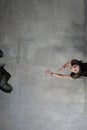 Woman dancer in motion tosses a scarf of translucent black material