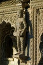 Woman dancer playing drum musical instrument carved in stone on the wall of Maheshwar Temple