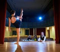 Woman dancing for audition with jury in theater