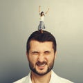 Woman dancing on the head of dissatisfied man Royalty Free Stock Photo