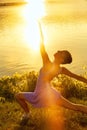 Woman dancing with intense reflections of the setting sun