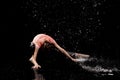 Woman dancing rain black background