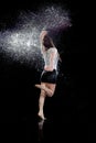 Woman dancing rain black background