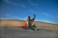 A woman dancing on the sand dunes