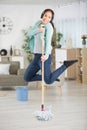 woman dancing and singling while mopping floor Royalty Free Stock Photo