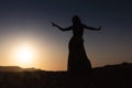 Woman dancing to the famous Arab belly dance. With sunset in the arid desert plain of Namibe. Africa. Angola Royalty Free Stock Photo