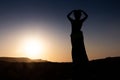 Woman dancing to the famous Arab belly dance. With sunset in the arid desert plain of Namibe. Africa. Angola Royalty Free Stock Photo