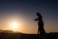 Woman dancing to the famous Arab belly dance. With sunset in the arid desert plain of Namibe. Africa. Angola Royalty Free Stock Photo