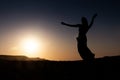 Woman dancing to the famous Arab belly dance. With sunset in the arid desert plain of Namibe. Africa. Angola