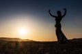 Woman dancing to the famous Arab belly dance. With sunset in the arid desert plain of Namibe. Africa. Angola