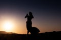 Woman dancing to the famous Arab belly dance. With sunset in the arid desert plain of Namibe. Africa. Angola Royalty Free Stock Photo