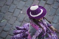 Woman dancing with typical Cuzco clothes with hats at the Inti Raymi Sun Festival, overhead view with Peru cobblestones background