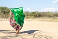 Woman dancing typical Wayuu dance. Indigenous culture of La Guajira, Colombia. Desert landscape